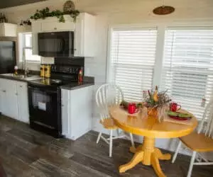 Dining room with kitchen from incredible tiny home model Titus made by Pratt Homes, Tyler, Texas