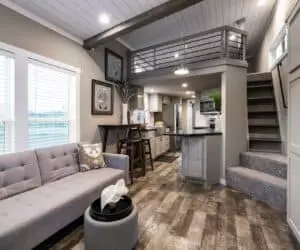 Living Room with kitchen of incredible tiny home Seaside made by Pratt Homes Tyler