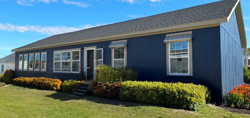 A large modular home with a nice, green lawn - the Molly modular home by Pratt Houses.